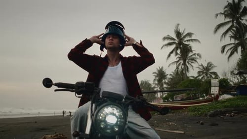 Man Putting Off Motorcycle Helmet Bali Male Motorcyclist Sitting on Motorbike Palm Tree