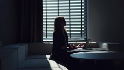 Office Worker Sitting at Desk with Modern Laptop and Meditating with Closed Eyes