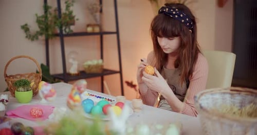 Young Girl Painting Easter Eggs for Easter Holidays