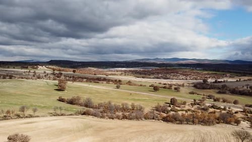 Aerial view highway and cars on wide terrain in cloudy weather 4K