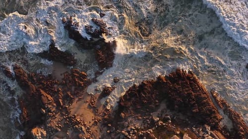 Dramatic Top Down Drone View Of Waves Crashing On Rocks