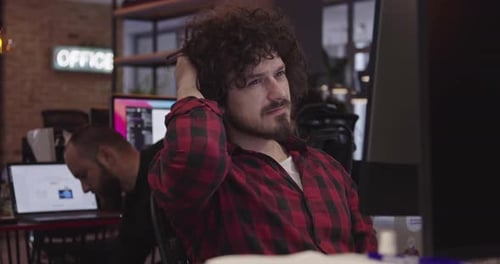 Businessman or Software Engineer Sitting in a Modern Coworking Office and Working at a Computer