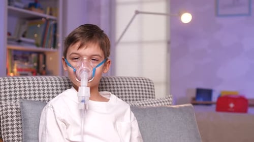 Child Using Nebulizer Mask for Respiratory Treatment