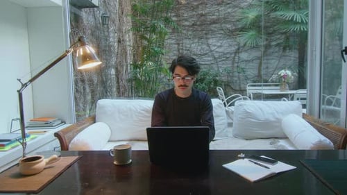 Man Working on Laptop in Modern Home Office