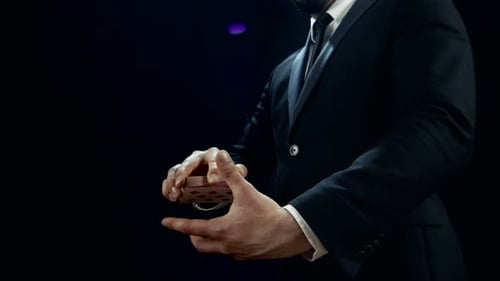 Close-up of a Magician's Hands Performing Card Trick. Throwing and Catching Cards in the Air. Backg