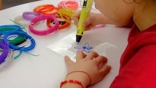 Child Creating a Flower with a 3D Pen