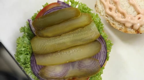 254q. Cooking a burger with cutlet and vegetables.