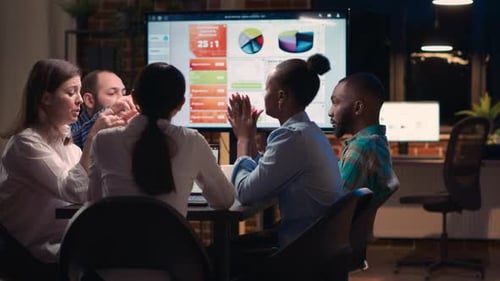 Business Team Collaborating During Late Night Meeting