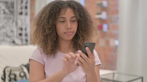 Woman Using Smartphone Indoors in a Close Up Shot
