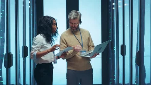 Employees in Data Center Using Laptop and Tablet