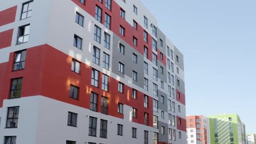 Slow Panning Shot of the Exterior Facades Colorful Highrise Urban Buildings with Red and Green