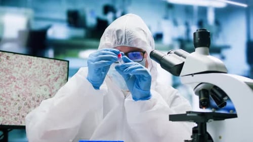 Researcher analyzing sample in laboratory with microscope