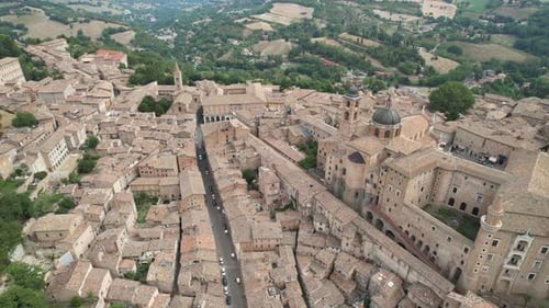 Aerial image showcases Urbino Main Street in Italy, capturing the historic architecture of the old t
