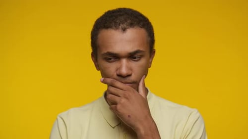 Young Man Thinking with Hand on Chin