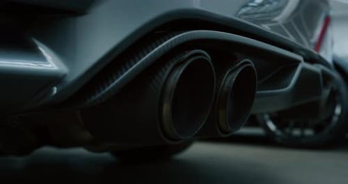 Close up of details of muffler of anonymous prestigious luxury modern car. Shot in 8K. Concept of