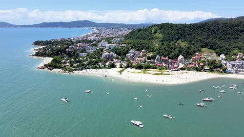 Aerial drone scene of paradise beach with many boats and yachts in the sea with pier and buildings f