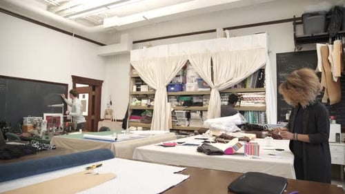 Fashion designers of various ethnicities collaborating in studio workshop