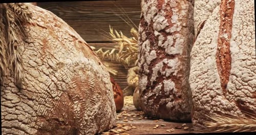 Closeup of grains in the bag and loaves of bread.