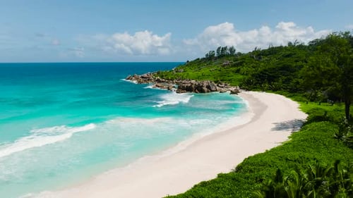 Turquoise Ocean and White Sand Beach with Green Surroundings La Digue Seychelles