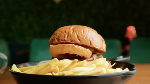 A Gourmet Burger Dish Served With Fries