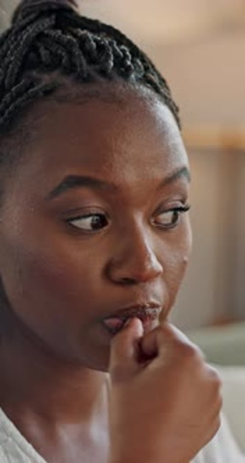 Woman, biting and hands for stress, anxiety or decision in home for closeup