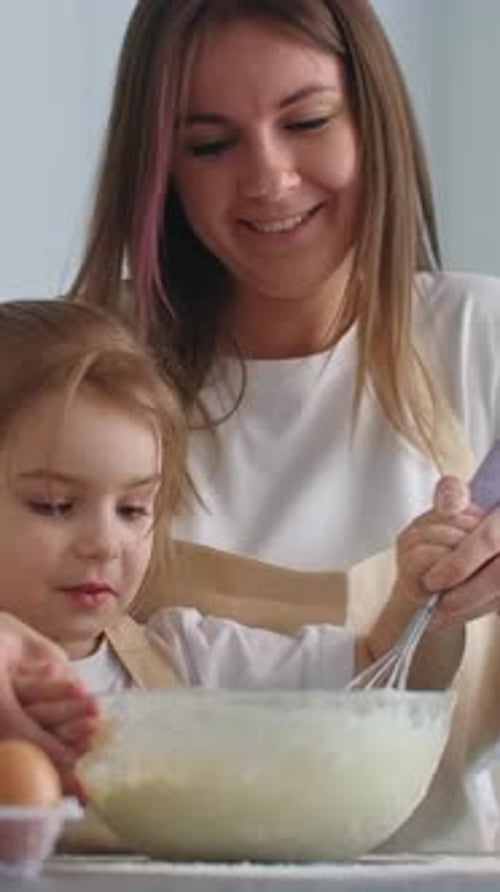 Woman and Girl Baking Together Indoors, Close Up