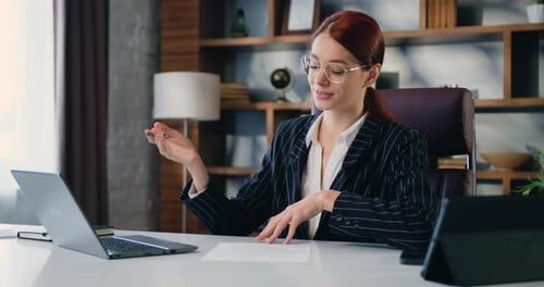 Young Woman Leads a Virtual Meeting in Office