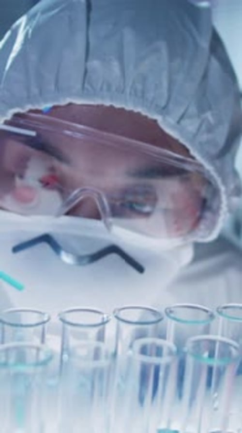 Close-up of Lab Technician Dripping Solution into Test Tube Using Pipette