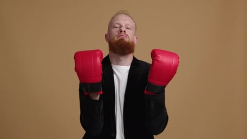Stern Man in Boxing Gloves Poses
