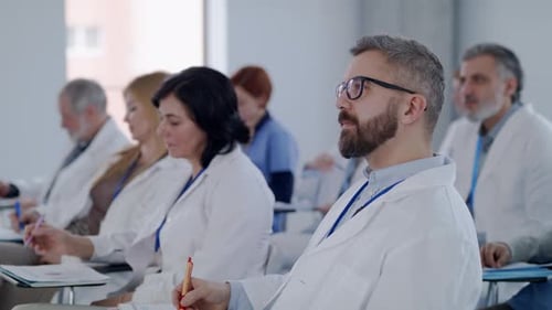Medical professionals attending a conference in a bright room