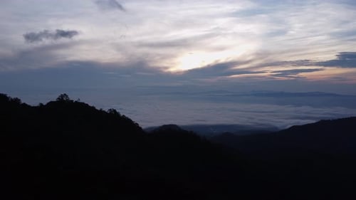 Aerial view of sea of fog on tropical mountains in the early morning.
