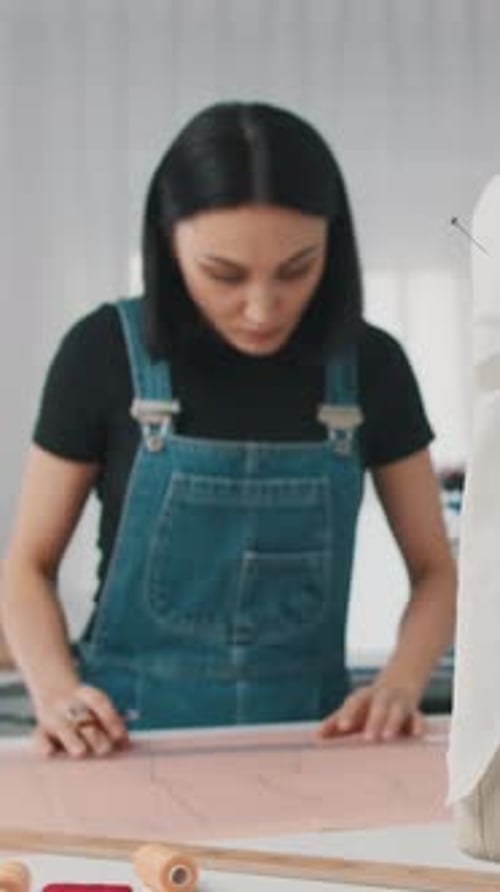 Woman Designs Clothes in Studio with Mannequin