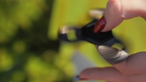 A Detailed CloseUp View of a Colorful Fidget Spinner Whirling in Motion Beneath Bright Sunlight