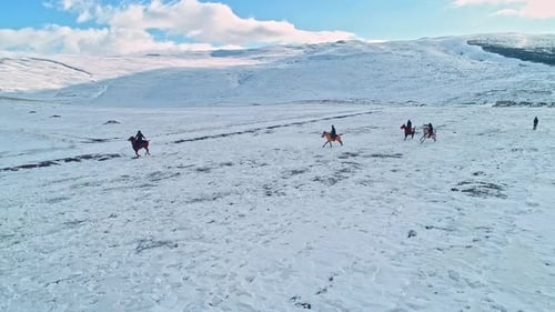 Horse Riders Journeying Across a Snowy Rural Landscape