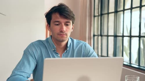 Business Man Working in Home Office and Typing on Keyboard of Laptop Computer