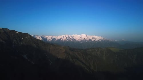 Tibetan Green Mountains in the Clouds During the Day Drone View