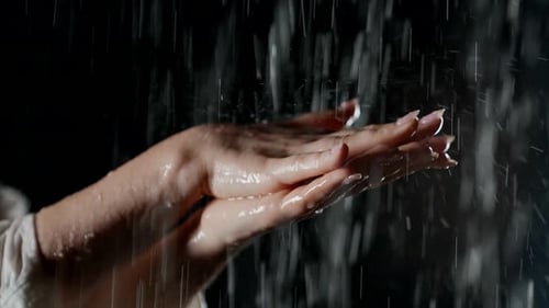 Female Hands with Manicure in Water Flow in Black Background Woman Washing Hands in Rain Closeup
