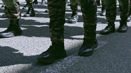 Close up of soldiers boots marching in formation during a parade