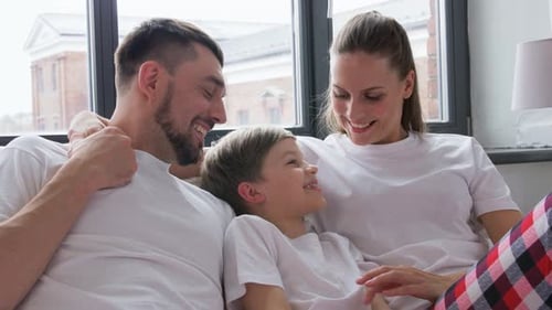 Happy family bonding on the bed together