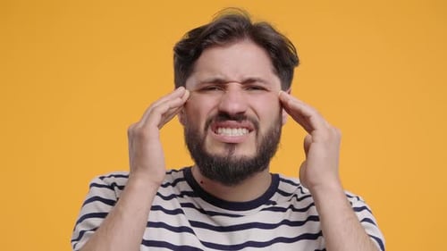 30s Aged Man in Yellow Wear Having Headache Studio Portrait Guy Putting Hands on Head Isolated on
