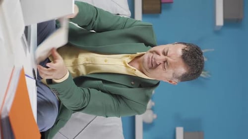 Vertical video of Home office worker old man is angry and furious