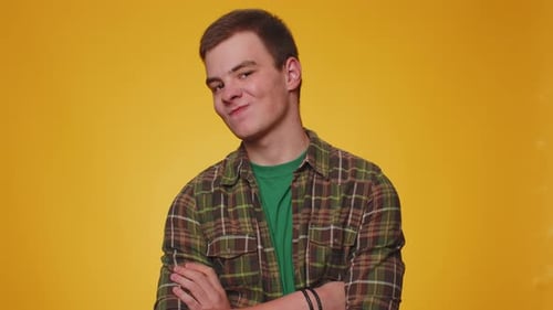 Young Adult Posing Against Yellow Backdrop