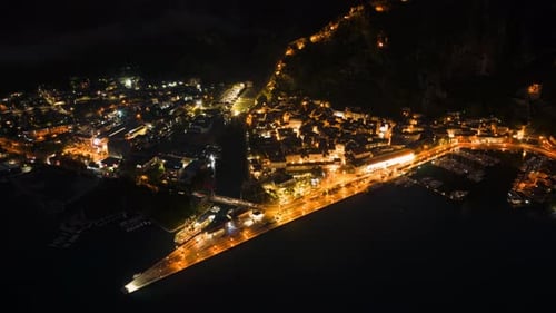 Aerial drone timelapse of Kotor, Montenegro at night with car traffic