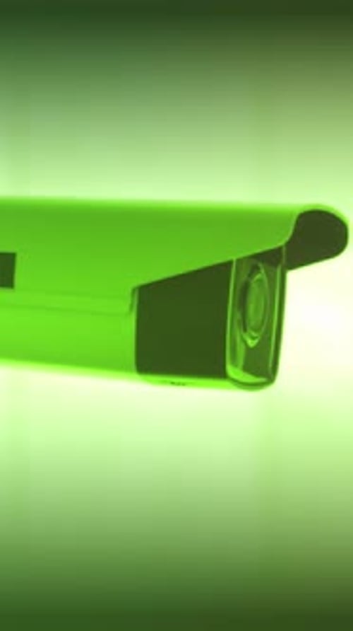 Reflective Housing Under Glowing Studio Light Security Camera with Bright Neon Illumination and