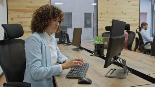 Businesswoman Working on Computer in Office Environment Business Concept