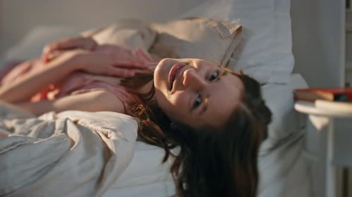 Woman Relaxing in Bed, Smiling