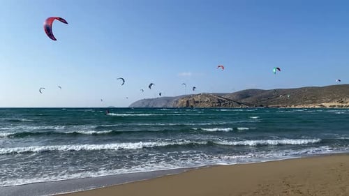 Surfers in Prasonisi Beach in Rhodes island, Greece. Kiteboarder kitesurfer athlete performing kites
