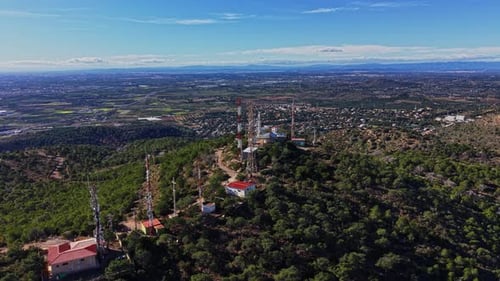 Communication towers on a hillside in Spain during daylight hours