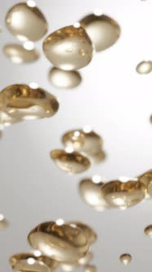 Golden Fluid Droplets Seamlessly Rising Upward