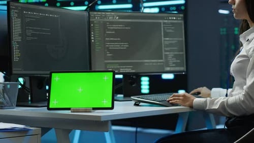 Woman Doing Maintenance on Server Room Infrastructure Using Chroma Key Tablet